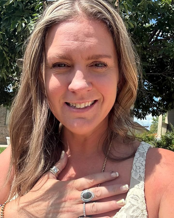 Amy Beth Andrews, smiling outdoors on a sunny day